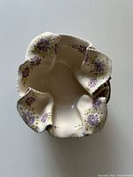 Top view showing ruffled cream interior with floral decoration