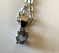 Front view of quartz crystal pendant on silver-tone chain