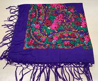 Full view of scarf showing floral pattern and fringe