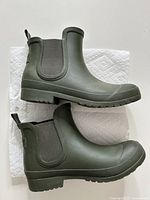 Side view of both green rain boots showing overall style, color and tread