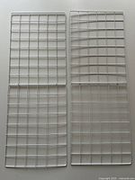 Two white metal grid panels laid side by side showing full shape and grid pattern