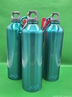 Three teal Jogi stainless steel water bottles group view