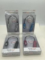 Front view of all four packaged Travel-FLEX book lights