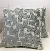 Two identical Threshold geometric cut-velvet throw pillows front view