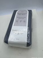 Front of sealed package showing Threshold Performance Flat Sheet label