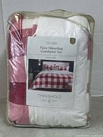Front of packaged Threshold faux shearling comforter set showing label and pattern