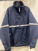 Front view of navy Tri-Mountain jacket showing reflective stripe, zipper and overall condition