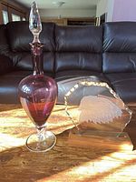 Amethyst decanter beside eagle etched glass plaque