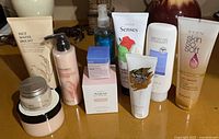 Full group view of all 10 unopened Avon and The Face Shop skincare items