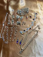 Group shot of all jewelry pieces laid out on fabric