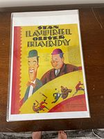 Front of Stan Laurel & Oliver Hardy playbill poster in protective sleeve