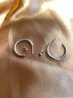 Both hoop earrings and backs laid flat showing overall design