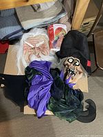 Grouped masks, packaged wig and fabric accessories on floor