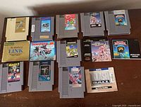 All 14 NES cartridges arranged on table with Zelda II booklet visible