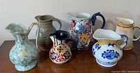 Group shot of six ceramic pitchers