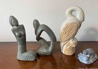 Four soapstone sculptures grouped on table