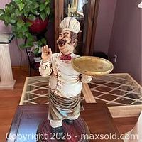 Full view of resin chef figure on stand with tray and raised hand