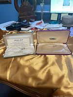 Both necklaces in their respective cases