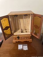 Closed view of wood jewelry armoire showing overall design