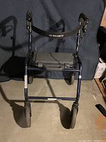 Front view of Dolomite rollator showing frame, wheels, back strap