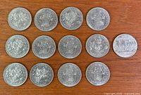 Fourteen Canadian commemorative dollar coins reverse side