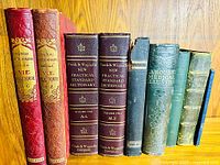 Front view of all eight hardcover books showing spines and titles