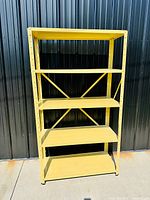 Full frontal view of yellow metal shelving unit