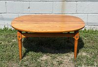 Angled front view showing full coffee table, round-square top, legs and stretcher