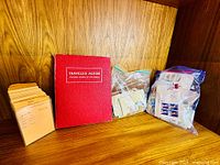 Album, stack of manila envelopes, two bags of loose stamps