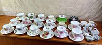 Wide shot showing full assortment of cups, saucers, cream pitcher and sugar bowl