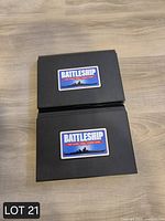 Two closed black Battleship cases with logo sticker