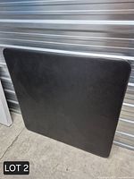 Front view of black square tabletop