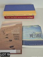 Stack of four inspirational books showing spines and covers