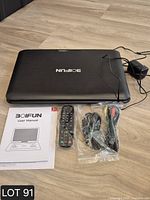 Portable DVD player closed with adapter, remote, AV cable, manual