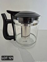 Full side view of Sipology tea steeper showing handle, lid, clear body, and infuser