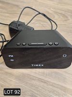 Overall view of Timex digital alarm clock and attached AC adapter