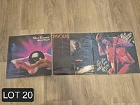 Front covers of the three sealed vinyl albums