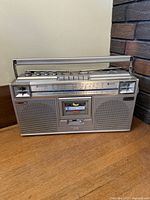 Front angled view of silver JVC RC-656LB boombox with handle extended