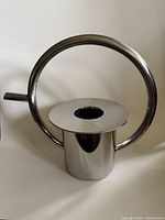 Front view showing entire stainless steel watering can with circular handle and spout