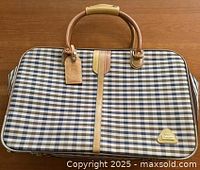 Front view of Aquascutum weekender showing check pattern, leather trim, logo plaque