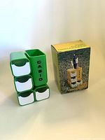 Front view of green Casio desk organizer beside box