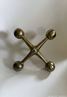 Front view of brass jack showing form and finish