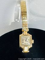 Full view of watch on display showing case and bracelet
