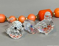 Both Swarovski crystal bird figurines side by side