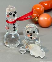 Front view of both crystal figurines showing details