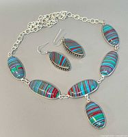 Necklace and earrings laid flat showing stone pattern and chain