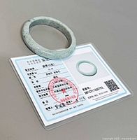 Jade bangle resting on side A of certification card