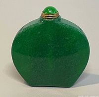 Front view of green jade bottle showing shape and stopper