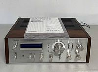 Front view of Pioneer SA-7800 amplifier with manual on top