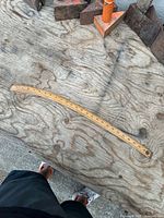 Full view of curved wooden ruler on work surface